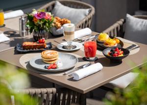 a table topped with plates of food on top of a table at Mandarin Oriental, Geneva in Geneva
