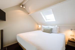 Ein Bett oder Betten in einem Zimmer der Unterkunft Van Heeckeren Hotel