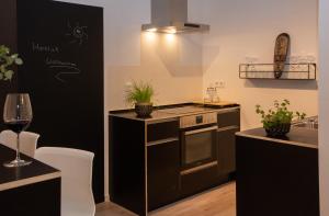 a kitchen with a stove top oven next to a counter at Art of living Mosel in Longuich