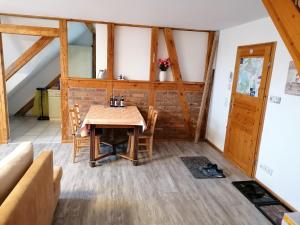 a dining room with a wooden table and chairs at Ferienwohnung Bensdorf in Bensdorf