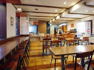 a restaurant with tables and chairs and a cafeteria at Hotel Aston Hotel Osaka Sakai in Sakai