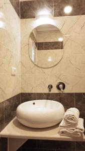 a bathroom with a white sink and a mirror at Ponte Apartments in Ulcinj