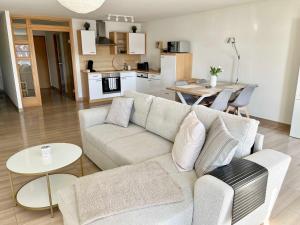 a living room with a couch and a kitchen at Ferienwohnung "wiederseen" Objekt ID 13721-1 in Waren +13 photos
