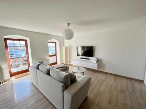 a living room with a couch and a tv at Ferienwohnung "wiederseen" Objekt ID 13721-1 in Waren