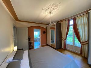 a bedroom with a bed and a large window at Magnifique villa à 5 minutes de Colmar in Horbourg +9 photos
