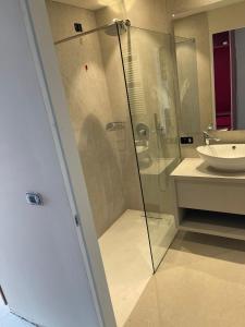 a bathroom with a glass shower and a sink at LLAC Living Nature Hotel in Limone sul Garda