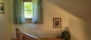 a staircase with curtains and a window in a house at Landhaus Fuggermühle 