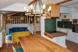 a kitchen with a table and a dining room at Villa Historia in Biecz