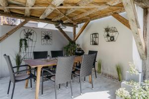a dining room with a wooden table and chairs at Ferienhaus25 in Purbach am Neusiedlersee