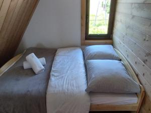 a bed in a small room with a window at Apartament u Bobaków 1 in Bańska Niżna