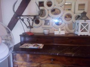 a desk with a fan and some mirrors on a wall at le Clos du Carriou in Lesgor