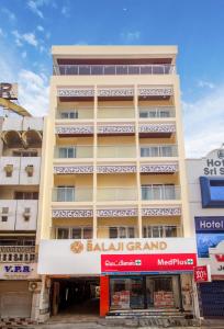 a building with a hotel in front of it at sri balaji grand hotel in Kumbakonam