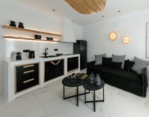 a living room with a black couch and a kitchen at Naxos Black Concept Maisonette in Naxos Chora