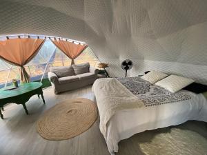 1 dormitorio con 1 cama grande y 1 sofá en Eco Spirit, en Tarifa
