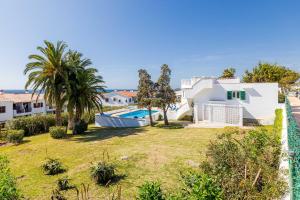 a house with a yard with a swimming pool at Villa SUN PARADISE in Son Bou