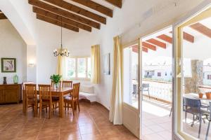 a kitchen and dining room with a table and chairs at Villa SUN PARADISE in Son Bou