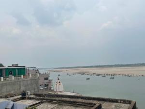 a view of a body of water with boats in it at Indra Paying Guest House in Varanasi