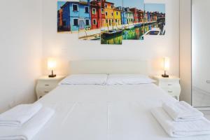 a bedroom with a white bed with two lamps at 15 - Tourist House Bologna Primaticcio - Self check-in in Bologna