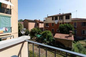 a balcony with a wine glass and some buildings at 15 - Tourist House Bologna Primaticcio - Self check-in in Bologna
