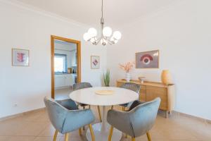 a dining room with a table and chairs at Boavista Charming Apartment in Lagos