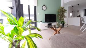 a living room with a table and some plants at Villa Wilhelmina in Torrevieja