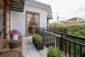 a balcony with two chairs and some plants at Sonti Villa in Seminyak