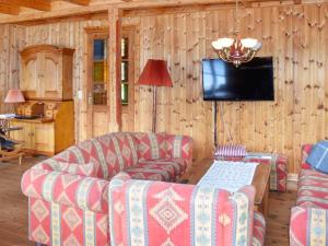 a living room with a couch and a tv at 8 person holiday home in Ørskog-By Traum in Ørskog