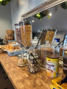 un mostrador con tarros de granola y tarros de frutos secos en Au Bec Fin Hôtel, en Aix-les-Bains