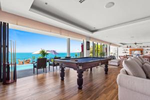 a pool table in a living room with a view of the ocean at Villa Samayra - An Oceanfront Pool Villa, Koh Samui in Chaweng
