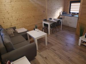 a living room with a couch and a table at Domki Całoroczne Danielowa Ostoja-Zator,Palczowice in Zator