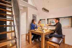 a group of people sitting at a table with wine glasses at Wohlfühlloft Seekretzer mit privatem Seezugang in Friedrichshafen