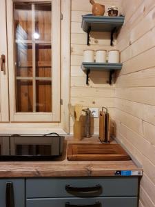 a kitchen with a counter with a sink and a microwave at Villa Skyline in Kotor