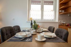 a dining room table with chairs and a dining room table at Apartments Pod Bregom in Kranjska Gora