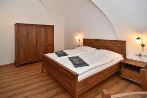 ein Schlafzimmer mit einem großen Bett und Holzmöbeln in der Unterkunft Zámek Račice in Račice
