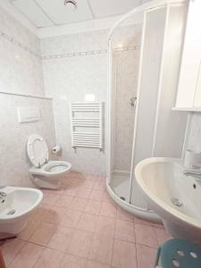 a bathroom with a shower and a toilet and a sink at Residence Paradiso in Laigueglia +16 photos
