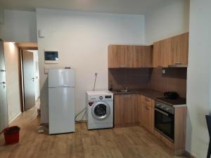 a kitchen with a refrigerator and a washing machine at Πάρκο Γουδή in Athens