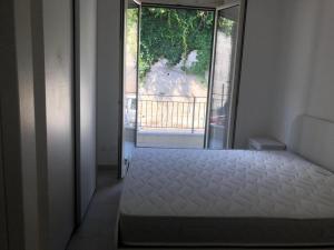 1 dormitorio con cama y ventana grande en Calanovella Mare Primo Piano 8, en Piraino