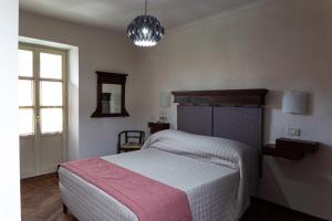 a bedroom with a large bed and a window at Maison Flipot in Torre Pellice