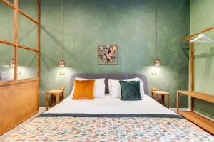 a bedroom with a bed with colorful pillows at Ripetta Natural Suites in Rome