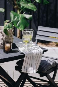 a glass on a table with a towel on it at 'The Studio' Designer, seaside cottage in Crawfordsburn