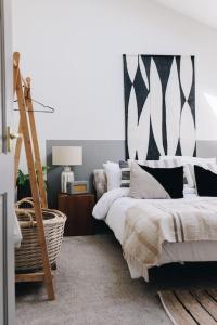 a bedroom with two beds and a ladder in it at 'The Studio' Designer, seaside cottage in Crawfordsburn
