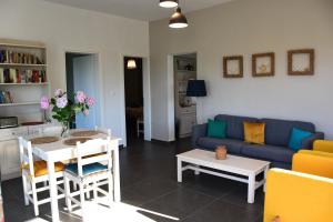 ein Wohnzimmer mit einem Sofa und einem Tisch in der Unterkunft Villa Monte Kariotes in Samothráki