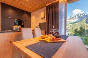 a kitchen with a table with a plate of fruit on it at Chalet Panorama Himmelreichhof in San Candido