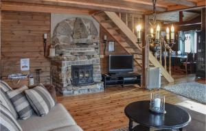 a living room with a couch and a stone fireplace at Beautiful Home In seral With 4 Bedrooms And Wifi in Åseral