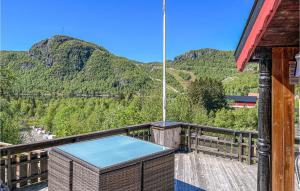 a hot tub on a deck with mountains in the background at Beautiful Home In seral With 4 Bedrooms And Wifi in Åseral