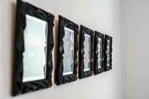 a row of mirrors hanging on a wall at Apartment Perlitto in Cres