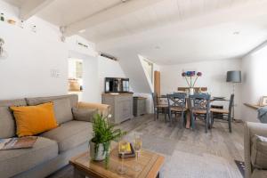 a living room with a couch and a table at Eastleigh Cottage, Marazion in Marazion