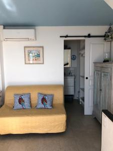 a living room with a couch with two pillows on it at La Maisonette Antibes in Antibes +21 photos