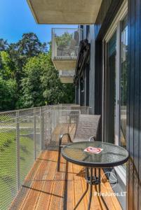 a balcony with a table and chairs on a porch at HAPPY SUMMER HOLIDAYS in Juodkrantė