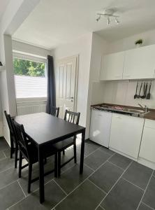 a kitchen and dining room with a table and chairs at Bernsteinsucher in Norden